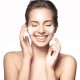 Woman happy cleanses the skin on a white background isolated